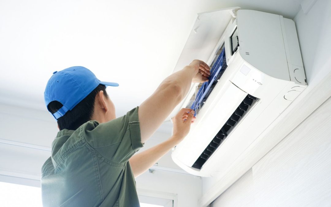 Air conditioning technician maintaining an indoor mini split system in Denver, CO