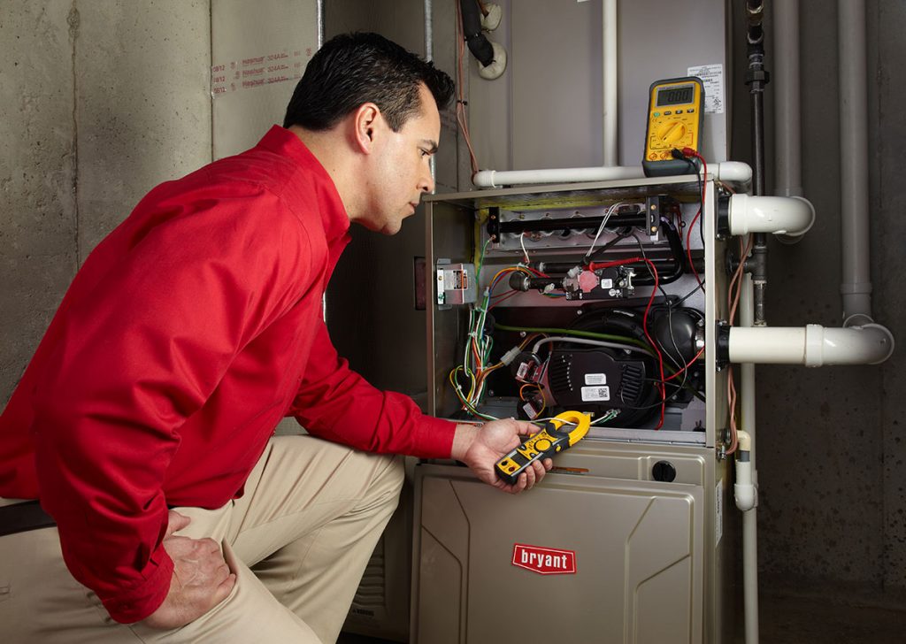 HVAC technician repairing an indoor furnace in Denver