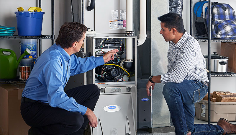 HVAC technician evaluating a furnace for repair or replacement in Denver