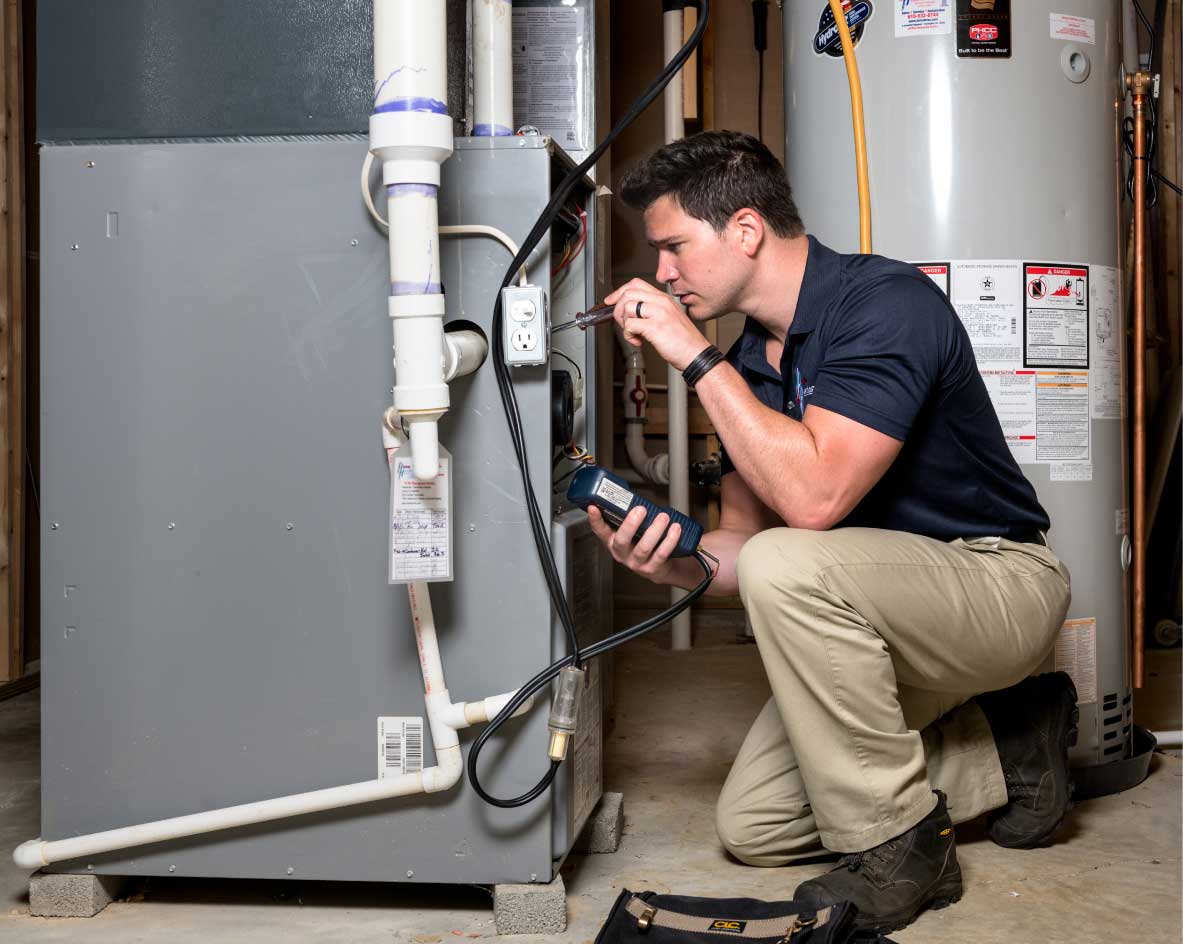HVAC technician performing a furnace tune-up in Denver