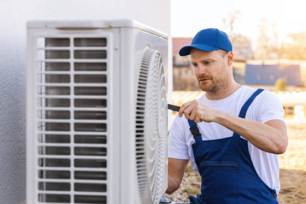 HVAC technician servicing an outdoor air conditioning unit in Denver