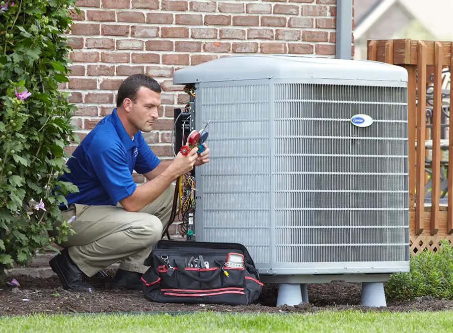 HVAC technician inspecting an outdoor air conditioning unit in Denver